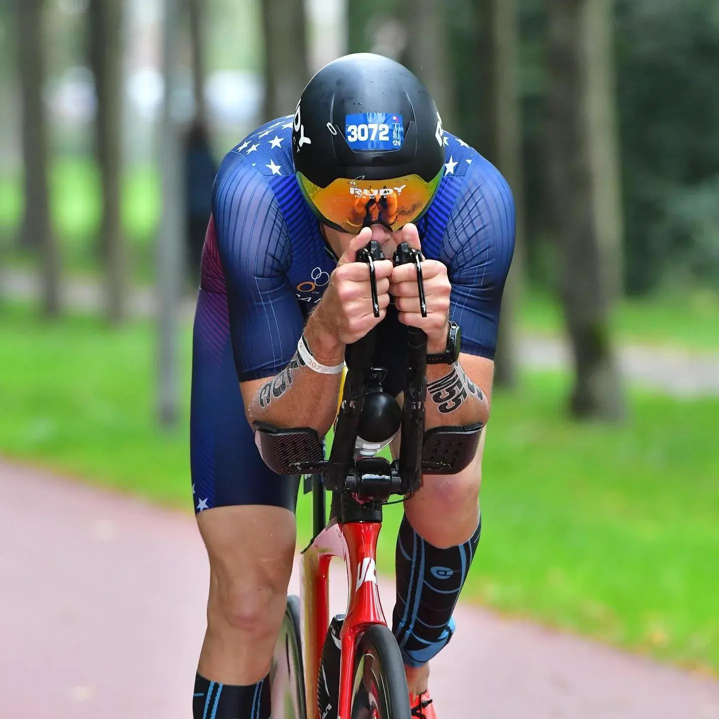 Rider in a deep aero position on a time trial bike
