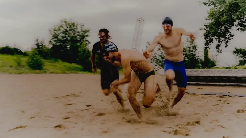 Athletes sprinting through sand